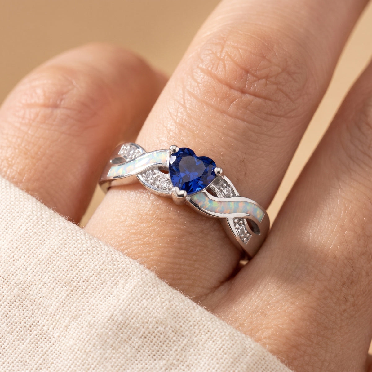 Blue Sapphire CZ White Lab Opal Heart Infinity Ring worn