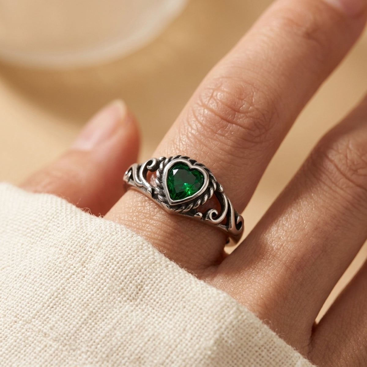 Braided Heart Swirls & Emerald CZ Ring worn